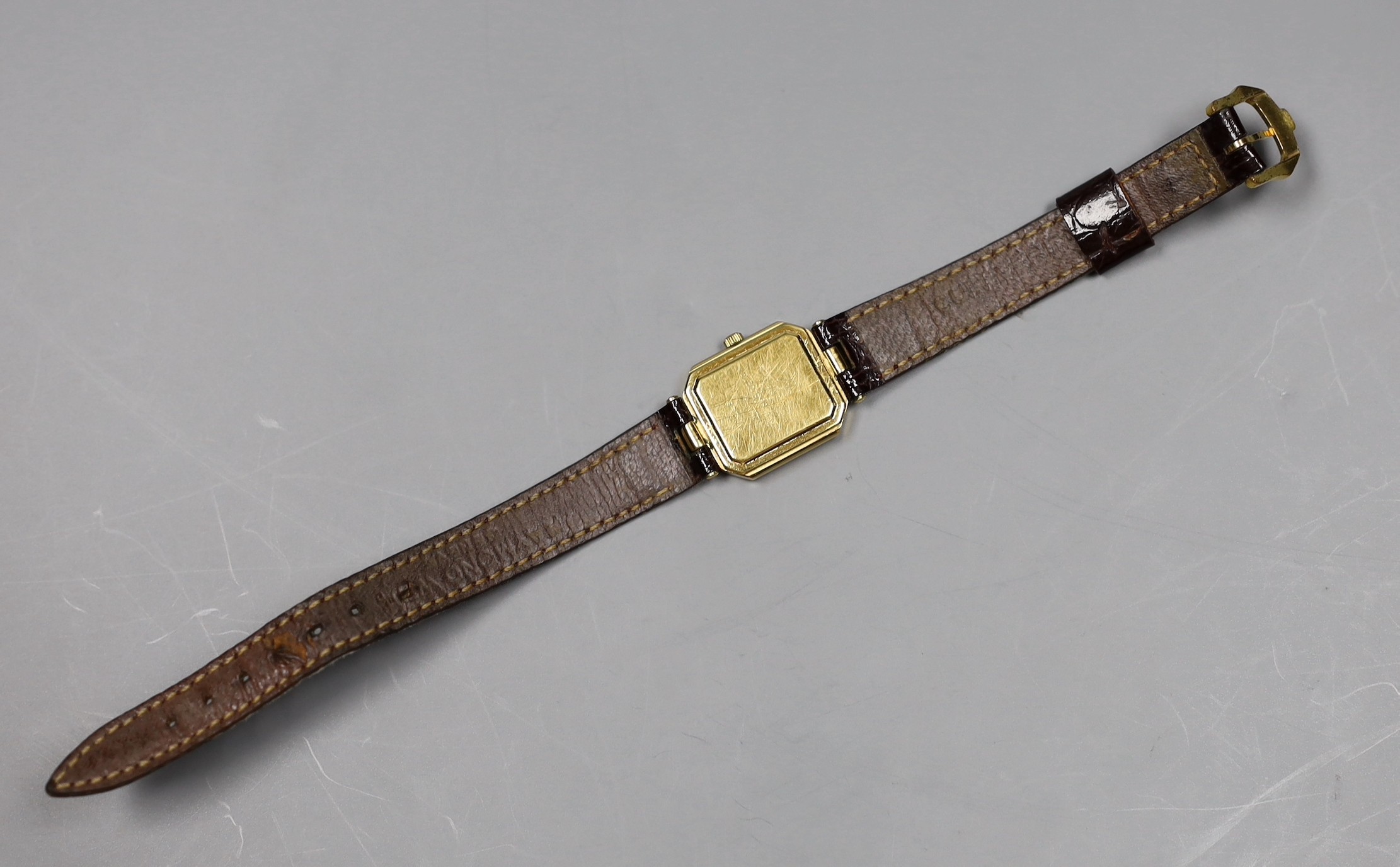 A lady's 18k gold electroplated Raymond Weil quartz wrist watch, with three colour dial, on a a leather strap, no box or papers.